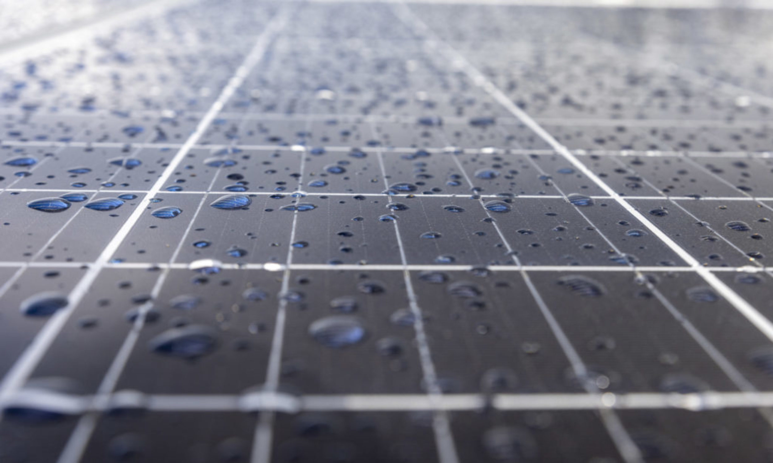 Solar panels on a construction site with raindrops on them
